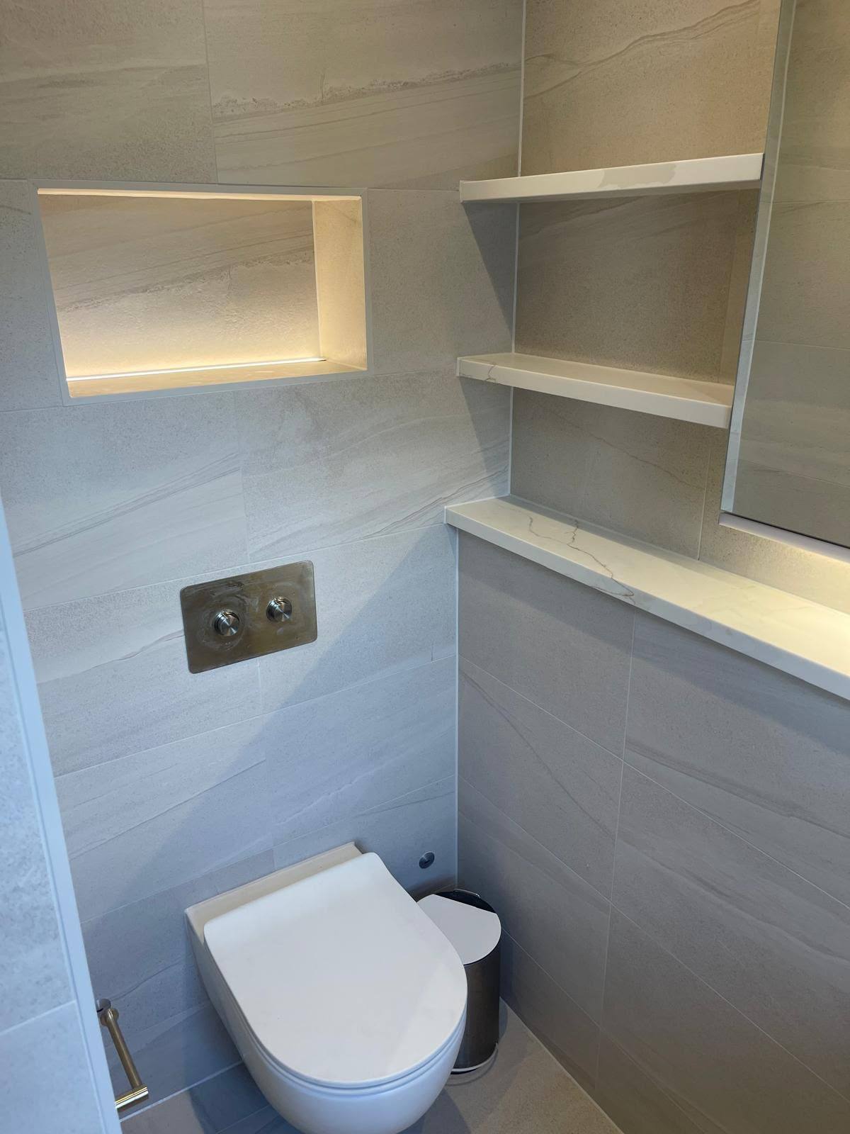Marble bathroom with an oval bath sealed to the surrounding stone floor