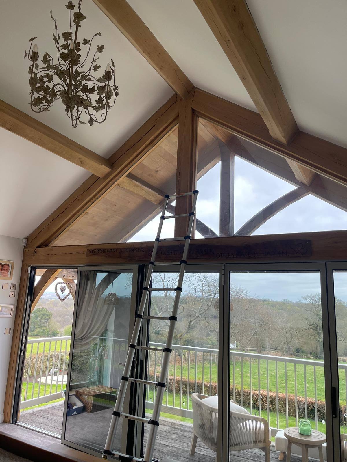 Large glass sliding doors sealed to a timber-beamed opening